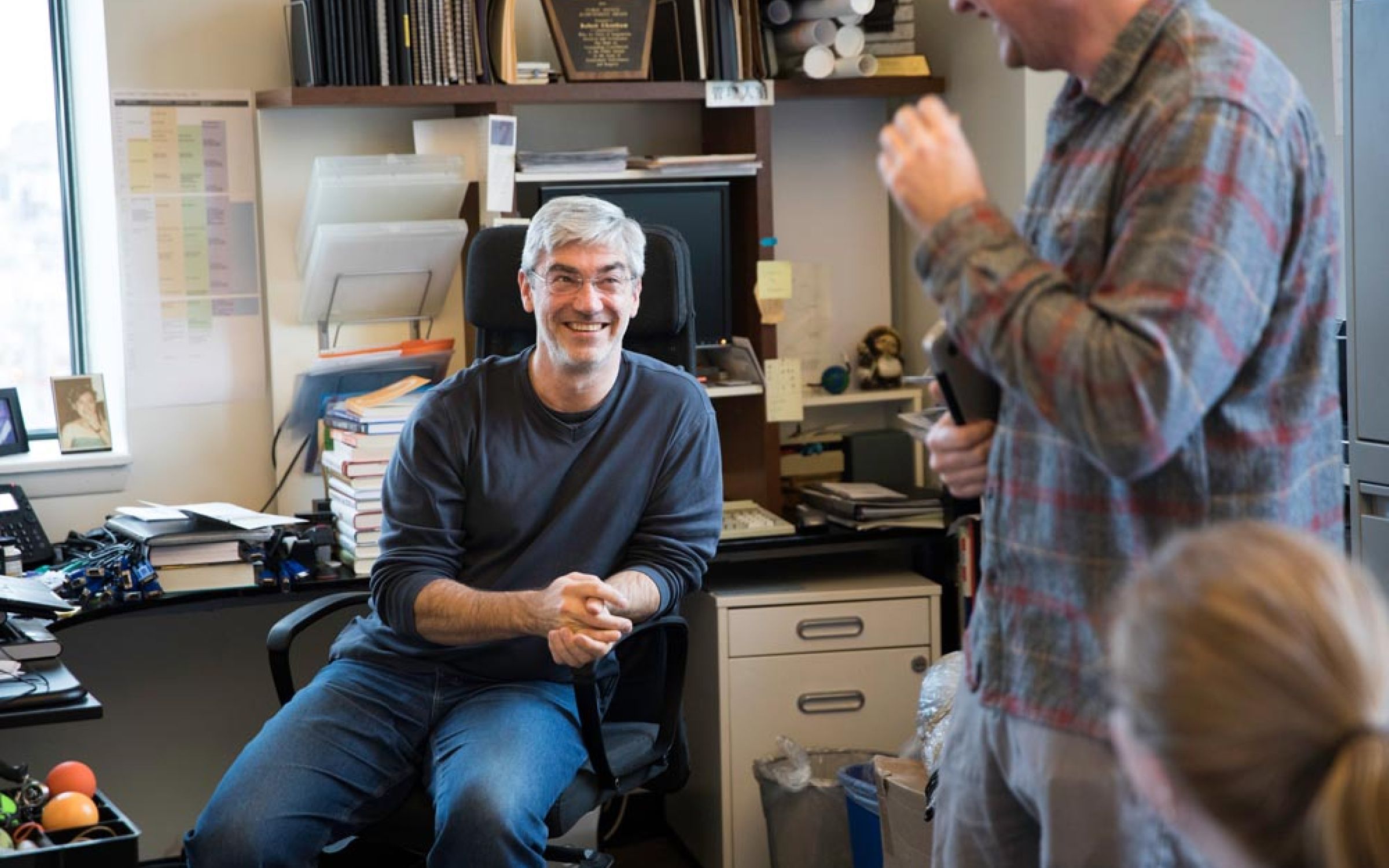 Art-directed photo of company owner and colleagues in the open office plan.